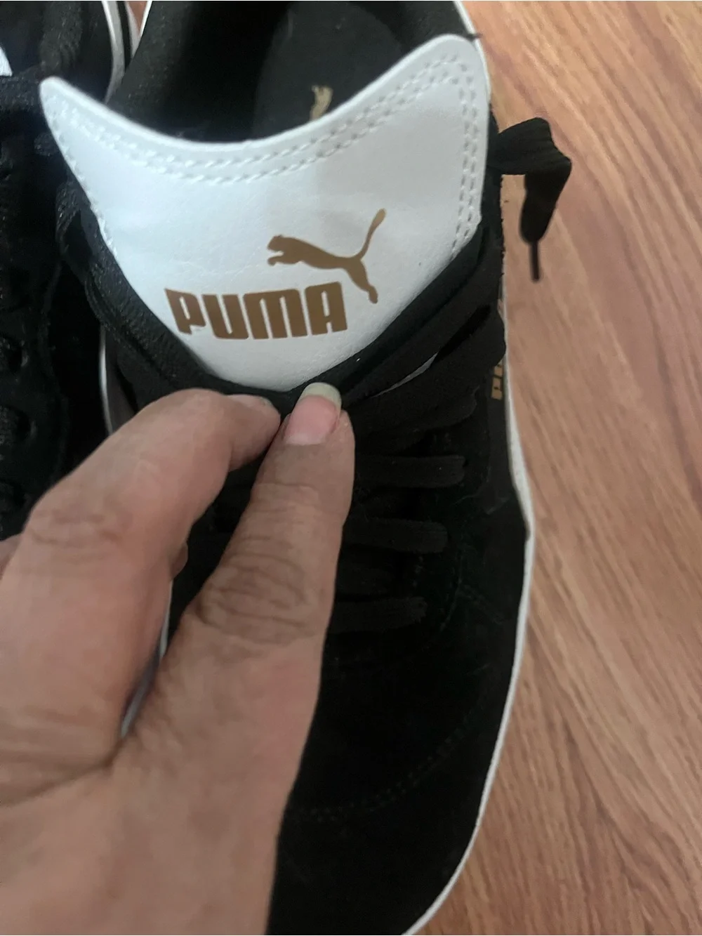Puma Black Suede Sneakers with White Tongue and Gold Logo